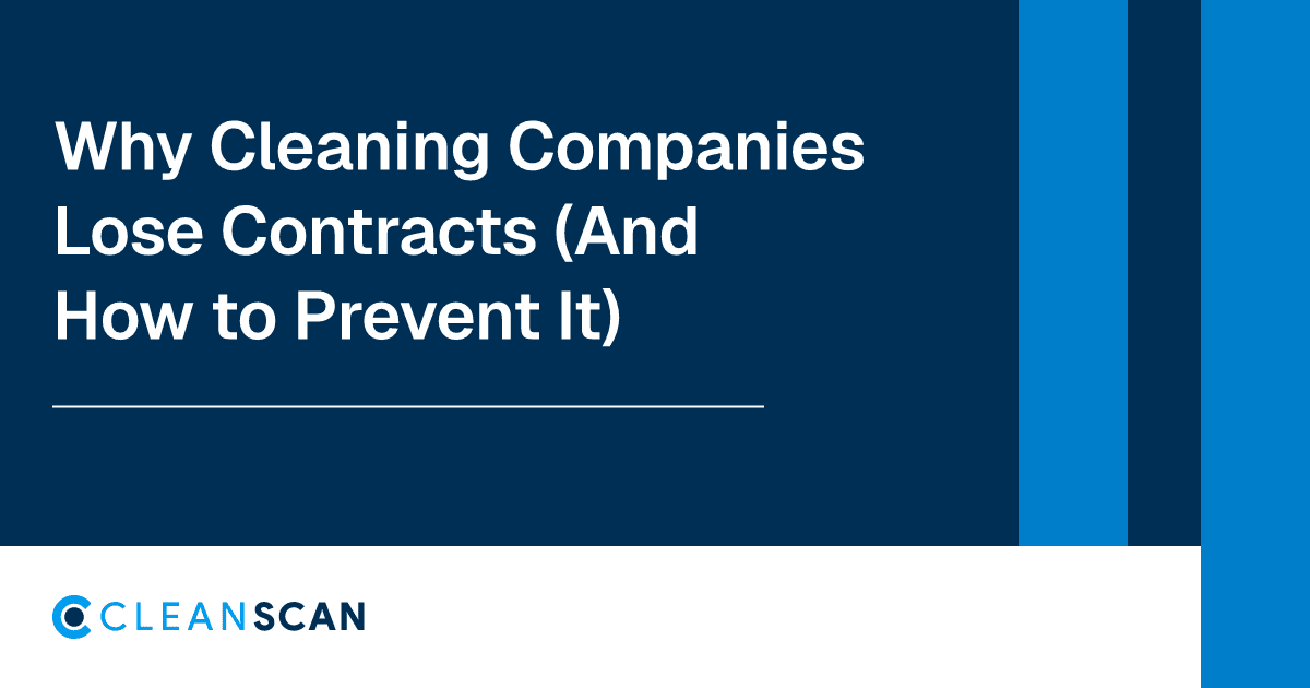 Hand tearing a contract document in half on a desk with glasses and a pen
